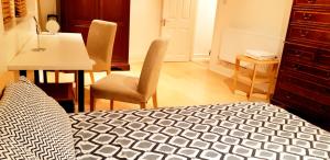 a bedroom with a bed and a table and chairs at Covent Garden Penthouse in London