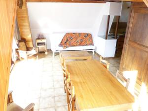 a room with a table and chairs and a couch at Le Relais des Ecrins in Saint-Christophe-en-Oisans