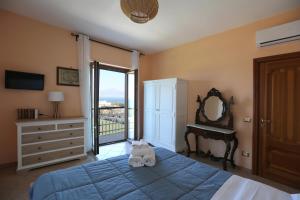 a bedroom with a bed with a cat laying on it at Sea&Skyview in Sorrento