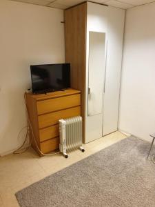
a small tv sitting on top of a stand in a room at Appartement Hotel Marien-Hof in Vienna
