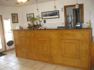 a kitchen with wooden cabinets and a white counter top at Heart of Texas Motel in Austin
