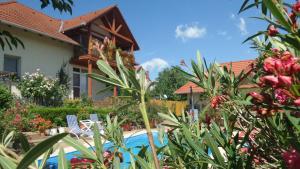 a house with a swimming pool and some plants at Haus Marika in Siófok