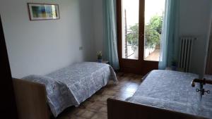 מיטה או מיטות בחדר ב-Casa Vacanze Breva