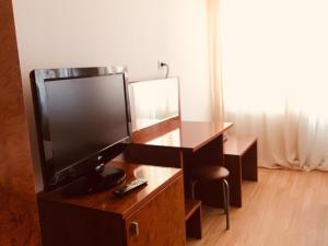 a living room with a tv and a desk at Casa Kito in Constanţa +17 photos