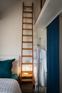 a bedroom with a ladder next to a bed at BC bed en comfort in Bilzen