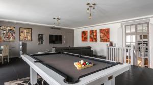 a living room with a pool table with a bowl of balls at Le Notre Dame - Luxury Apartment with Seine View in Paris