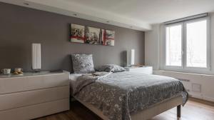 a bedroom with a bed and a window at Le Notre Dame - Luxury Apartment with Seine View in Paris