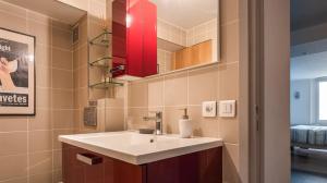 a bathroom with a sink and a red mirror at Le Notre Dame - Luxury Apartment with Seine View in Paris +22 photos