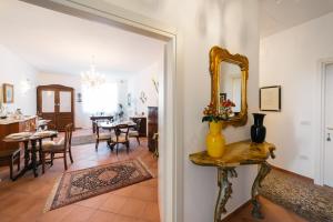 a hallway with a mirror and a dining room at BB Porta Augustea - Fano in Fano