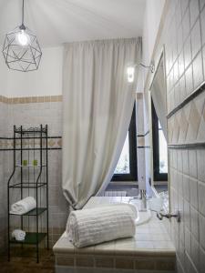 a bathroom with a tub and a sink and a window at Villa Borghese B&B in Foggia