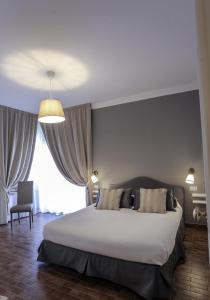 a bedroom with a large bed and a large window at Villa Borghese B&B in Foggia