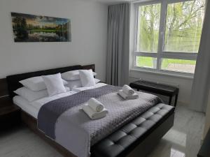 Posteľ alebo postele v izbe v ubytovaní Apartmány Urban