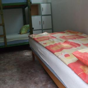 a bedroom with a bed and a bunk bed with a blanket at KEMPIN - KANTIN egyéb szálláshely in Bázakerettye