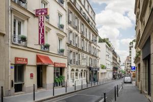 an empty street in a city with buildings at Hotel Elysée Etoile in Paris