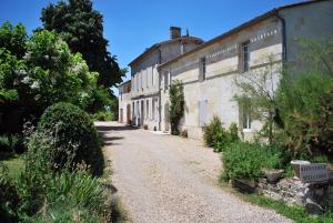 un camino vacío delante de un edificio en La Gomerie Chambres d'Hotes en Saint-Émilion