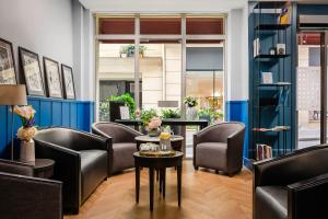 a waiting room with leather chairs and a table at Hotel Elysée Etoile in Paris