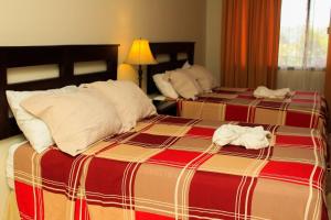 Giường trong phòng chung tại Plaza Magdalena Hotel