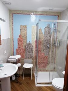 uma casa de banho com um chuveiro e um mural da cidade na parede em Borgo Manfria em Gela