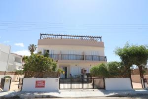 a white building with a balcony on top of it at The Paradise Townhouses By Taimoura in Paphos