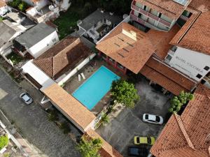 an overhead view of a house with a swimming pool at Hotel Ciconha in São Lourenço