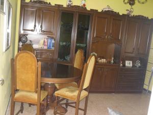 a dining room with a wooden table and chairs at Appartamenti Il Leone in Pienza +5 photos