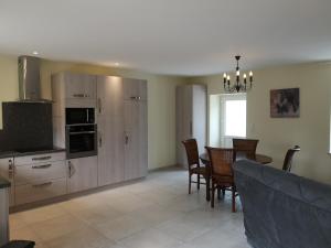 a kitchen and dining room with a table and chairs at Les gites Haras Del Paradiso in Boitron