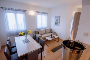 a living room with a couch and a dining room at Apartman Sea view in Brist