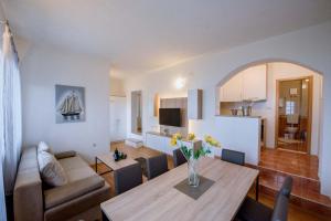 a living room with a table and a dining room at Apartman Sea view in Brist