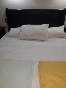 a large white bed with two pillows on it at 321or322 the finest Porto Marina Chalets Tower 3 in El Alamein