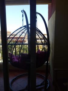 a bird cage is hanging from a window at 321or322 the finest Porto Marina Chalets Tower 3 in El Alamein