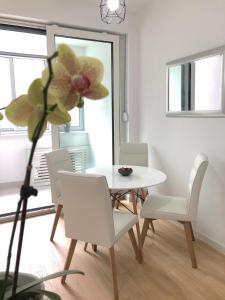 a dining room with a white table and white chairs at Ocean Apartment in Zagreb