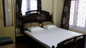 a bed with two pillows on it in a room at Flyer Exotica in Shimla