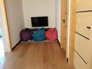 a room with three bags sitting next to a television at La maison des savoyards in Husseren-Wesserling