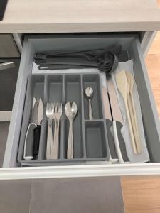 a drawer filled with utensils in a cabinet at Ocean Apartment in Zagreb