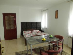 a bedroom with a bed and a table with chairs at Gościniec Suwalska in Gołdap