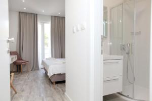 a bedroom with a bed and a bathroom with a shower at Villa Marija in Slatine