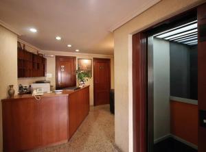 a kitchen with wooden cabinets and a counter top at Hotel Cristaleiro in Gondomar