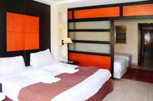 A bed or beds in a room at Rehana Royal Beach Resort - Aquapark & Spa - Family & Couples Only - Premium Ultra All-Inclusive 24H