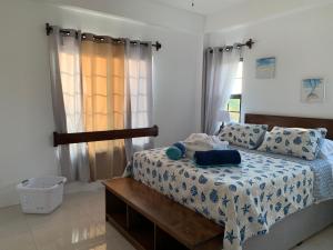 a bedroom with a bed and a window at Bay Towers in Caye Caulker