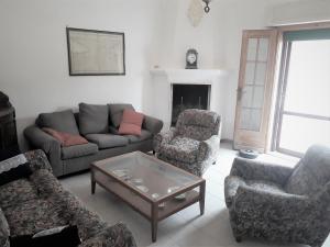 a living room with a couch and chairs and a table at Tenuta Argiano in Mesagne