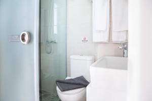 a bathroom with a toilet and a sink and a shower at Akti Dimis Hotel in Tigaki