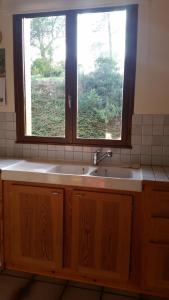 a kitchen with a sink and a window at Le Cers in Ribaute