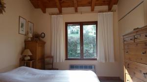 a bedroom with a large bed and a window at Le Cers in Ribaute