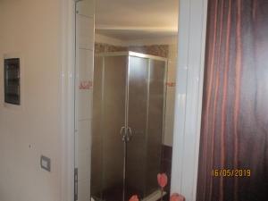 a shower with a glass door in a bathroom at Vila Horizont Ksamil in Sarandë +26 photos