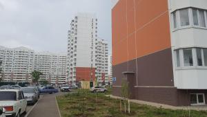 a parking lot with cars parked in a city at Apartment on Artushkova in Krasnodar