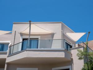 a balcony on the side of a building at Eva Mare Hotel & Suites - Adults only in Agia Pelagia