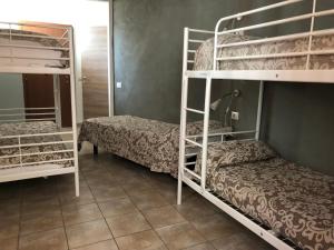 a room with two bunk beds and a bed at Ostello Old Milano in Milan