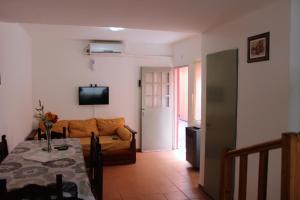a living room with a couch and a table at Complejo Kalifornia in Pilar