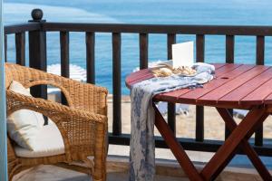 a wooden table with a towel on it on a balcony at Porto Sisi Hotel Apartments in Sisi