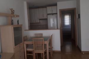 a kitchen with a table and chairs and a refrigerator at Gare de Madrid in Madrid